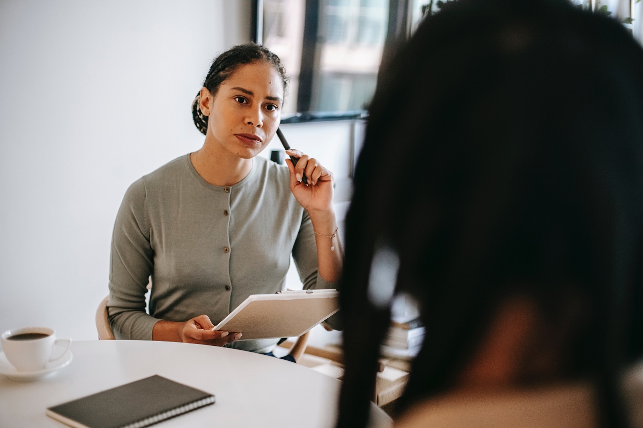 Woman listening to customer's complaint