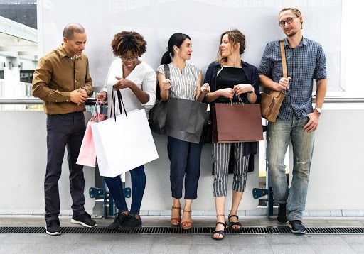 group-of-people-standing-with-shopping-bags group of people standing around with shopping bags