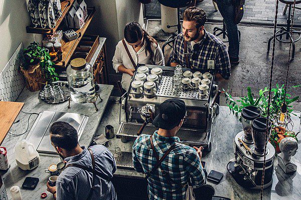 Coffee-shop-counter-with-baristas-and-customers Coffee shop counter with baristas and customers