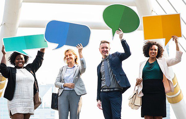 group-holding-message-bubbles-over-heads-smiling group holding message bubbles over their heads and smiling