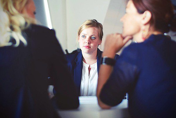 Woman-looking-at two-women Woman looking at two women