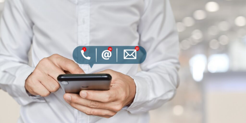 Businessman hand holding mobile phone with address, phone, email icon